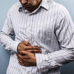 Man in pain with hands on his stomach